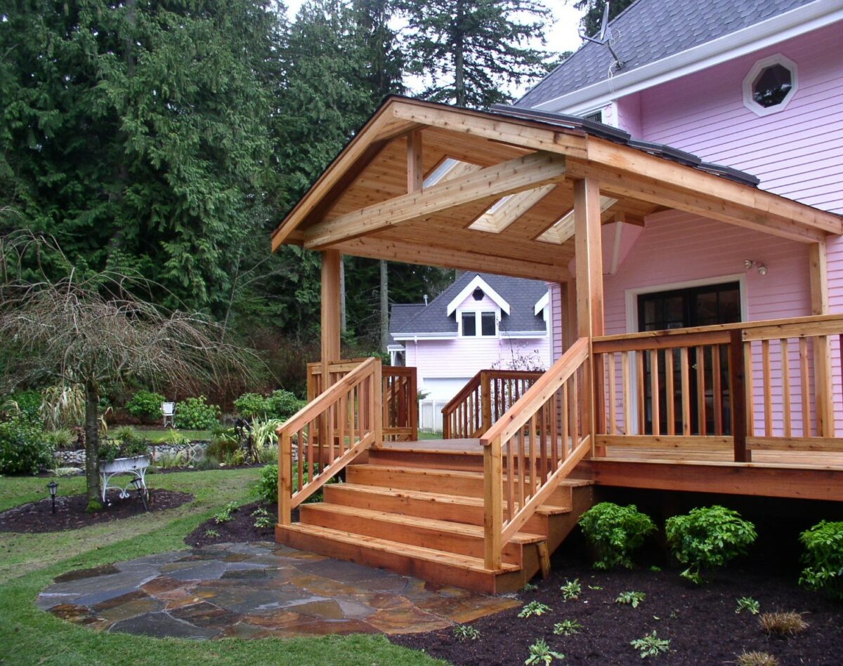 Custom wood desk, patio and owning created for a residence in Seattle, Washington also includes a paver patio landing with fresh landscaping and mulch.