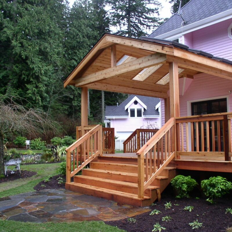 Custom wood desk, patio and owning created for a residence in Seattle, Washington also includes a paver patio landing with fresh landscaping and mulch.