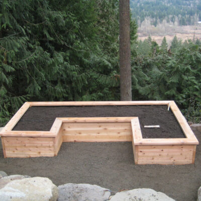 U-shaped custom cedar wood garden bed overlooking national forest in backyard in Seattle.