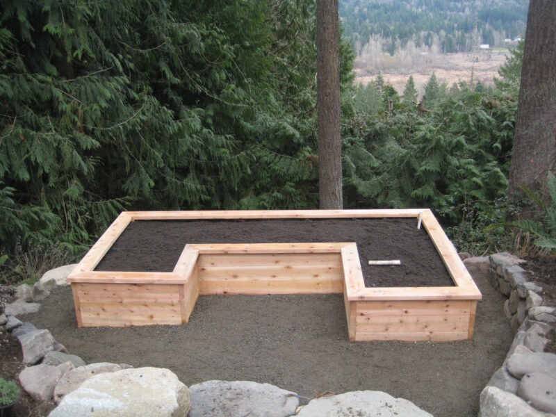 U-shaped custom cedar wood garden bed overlooking national forest in backyard in Seattle.