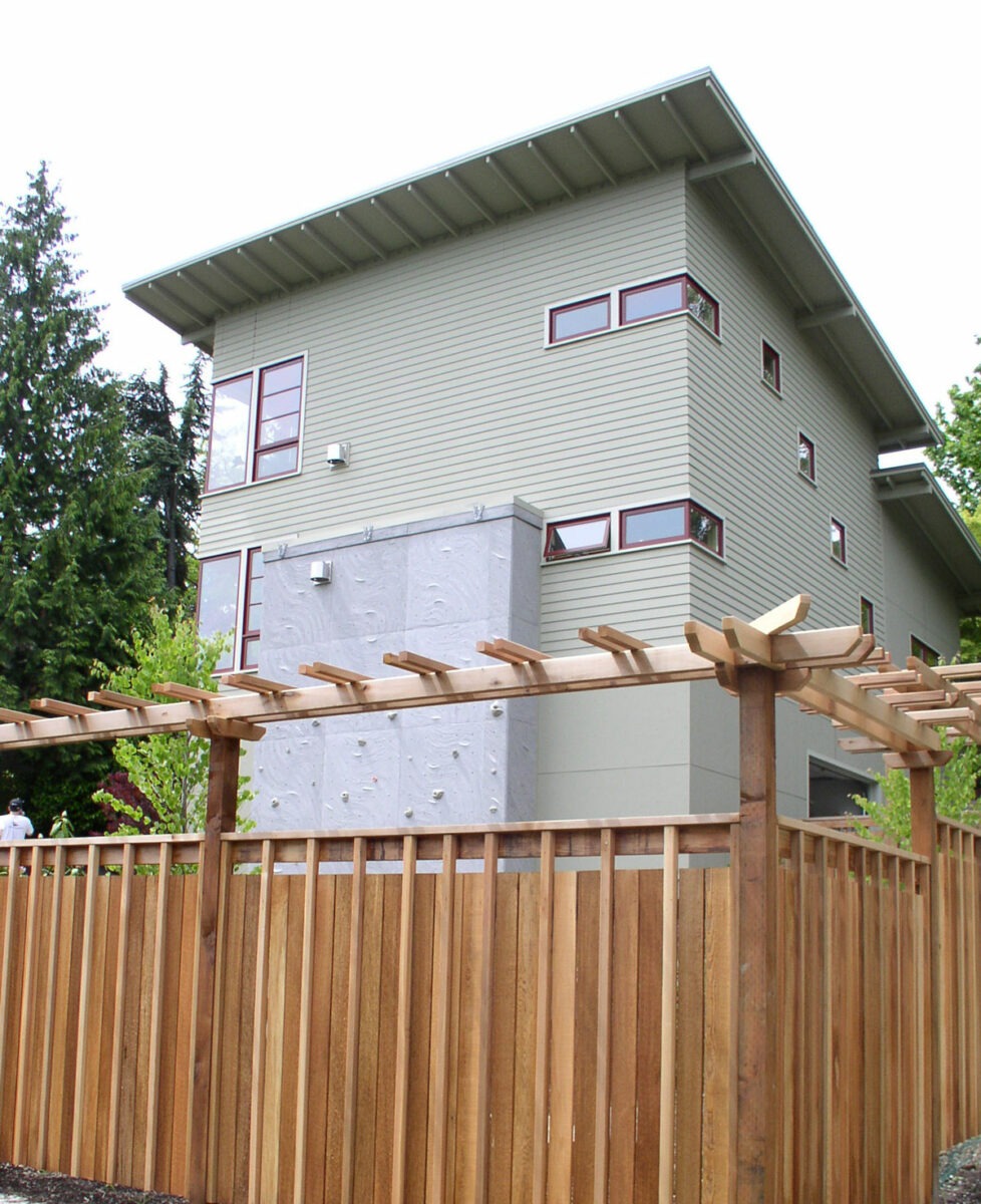 Custom and contemporary fence created for a residence near Seattle, Washington boasts a pagoda type styling on the top of the railing.
