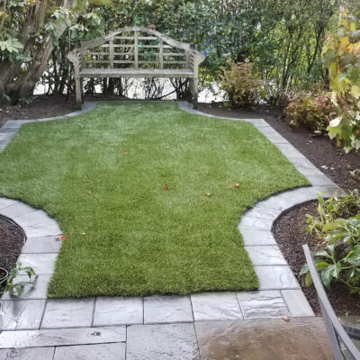 Small turn lawn is lined with pavers to create a nice sitting area in back yard of a Seattle, Washington home.