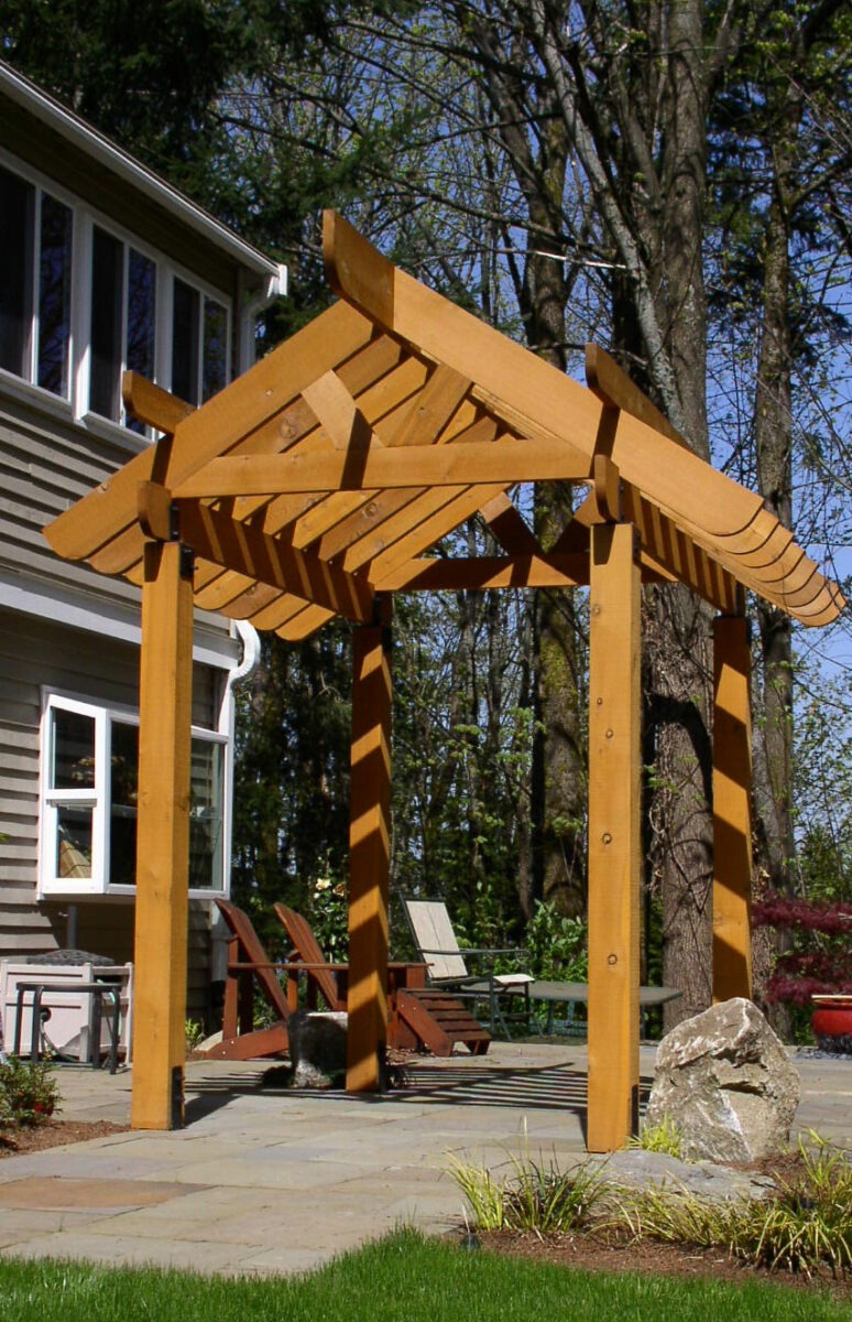 Builders of custom wood structures such as this Japanese style pagoda set atop of a paved patio in a residence in Seattle, Washington.