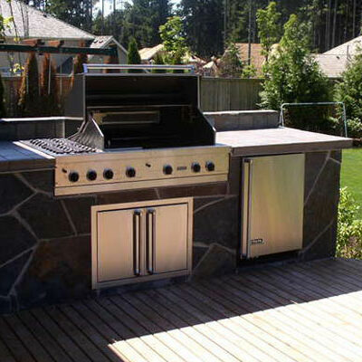 Create a unique space in your backyard with an outdoor grill and kitchen designed by Lifestyle Landscapes in Seattle, Washington.