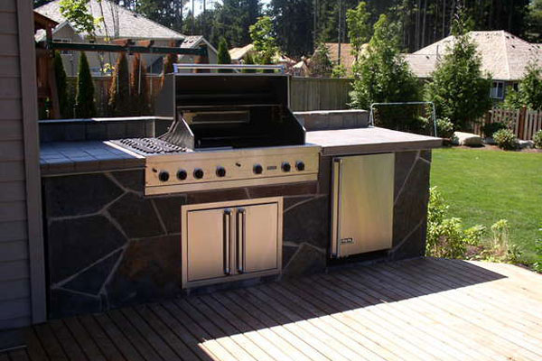 Create a unique space in your backyard with an outdoor grill and kitchen designed by Lifestyle Landscapes in Seattle, Washington.